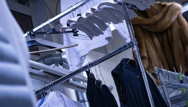 a clothes rack with clothes hanging on it