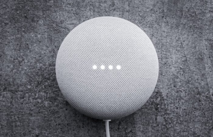 round white portable speaker on black textile