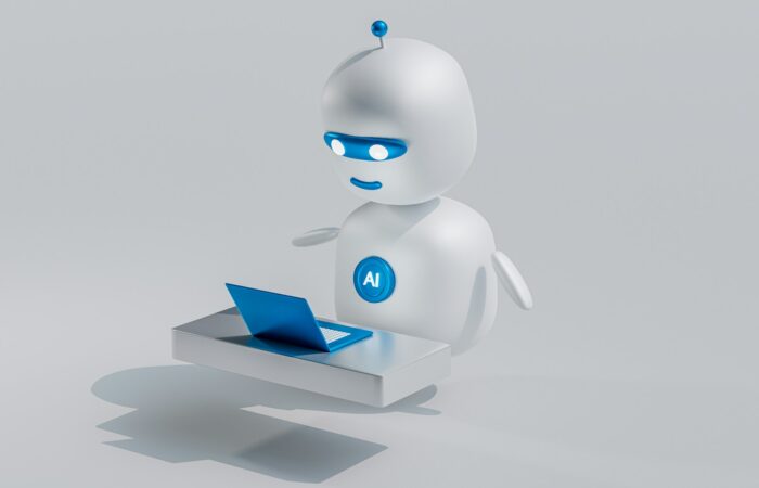 a white robot with blue eyes and a laptop
