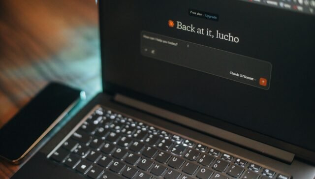 Laptop screen says "back at it, lucho".
