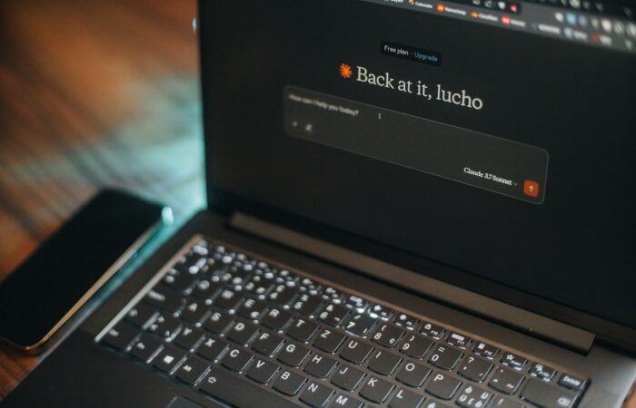 Laptop screen says "back at it, lucho".