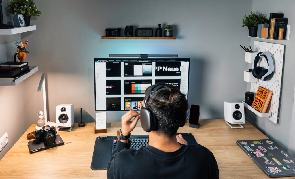 a man sitting at a desk with headphones on