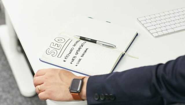 a person writing on a piece of paper
