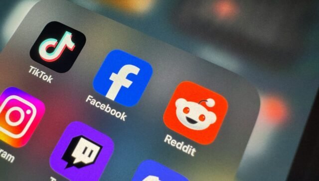 a close up of a cell phone with social icons on it